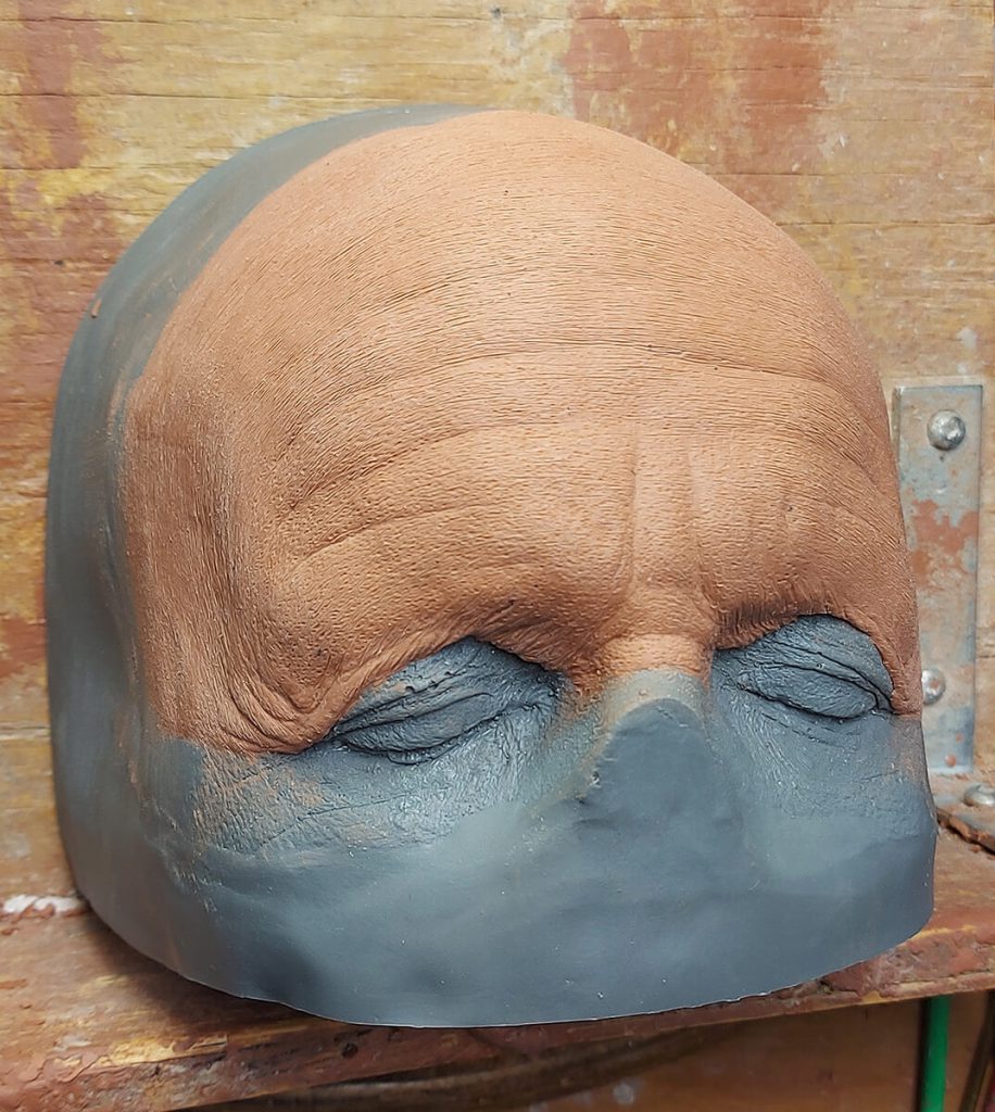 Painkiller - Blending edges of clay sculpture onto urethane forehead positive of Clark Gregg.